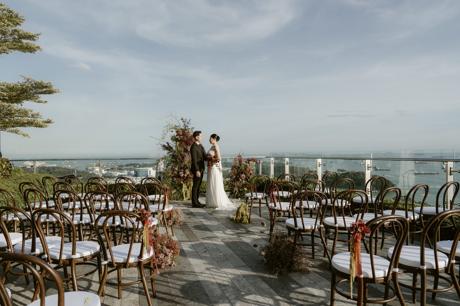 Rooftop wedding solemnisation at 1-Alfaro with ceremony seating, floral arch and panoramic Singapore views