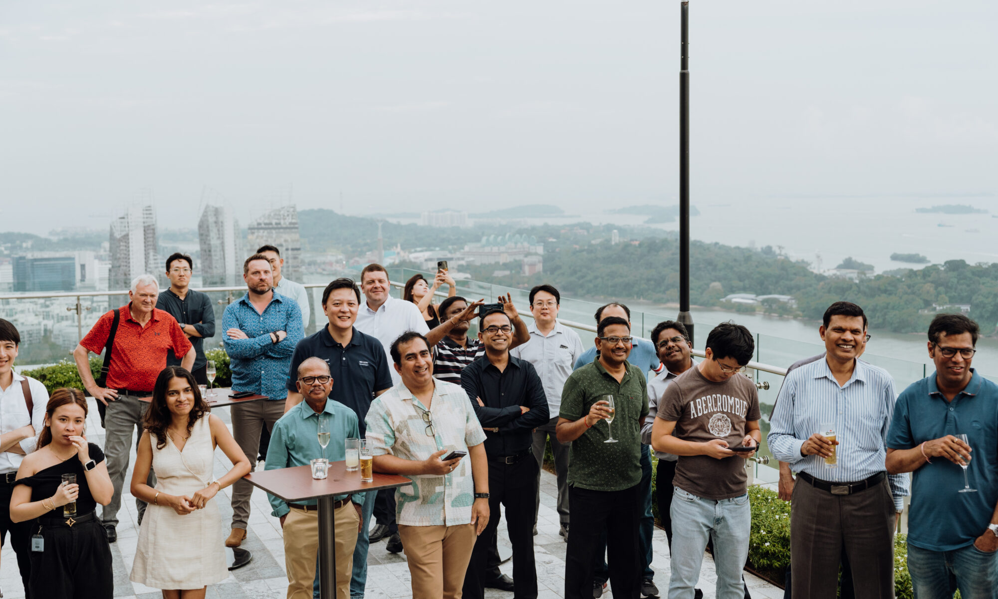 Group gathering on the La Luna rooftop at 1-Alfaro with Singapore skyline views